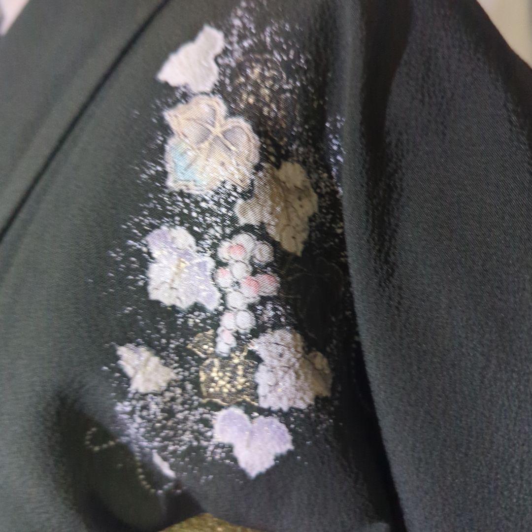 落款が入ります、青丹色の地に煌めく葡萄柄が繊細な美しさを見せる正絹訪問着です