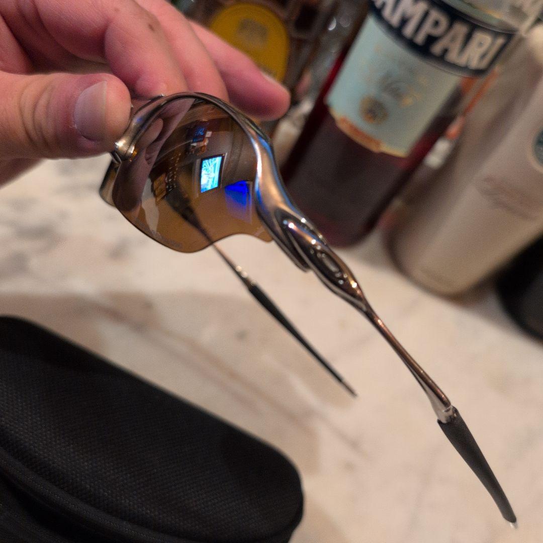 Oakley サングラス ブラウンレンズ シルバーフレームチタンカラーレンズ