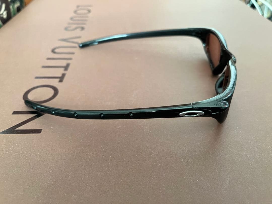 Oakley スポーツサングラス 黒 オレンジの度付きレンズ