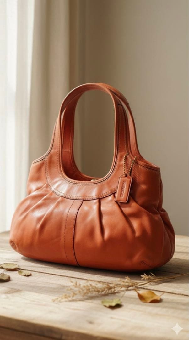 コーチ　オレンジ　エルゴレザープリーテッドフレームドサッチェル