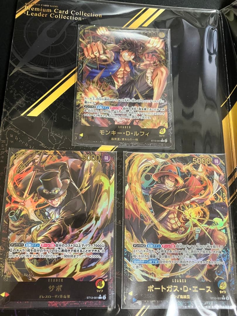 ワンピースカード　プレミアムコレクション等7冊未開封プロモ付25周年REDリーダ